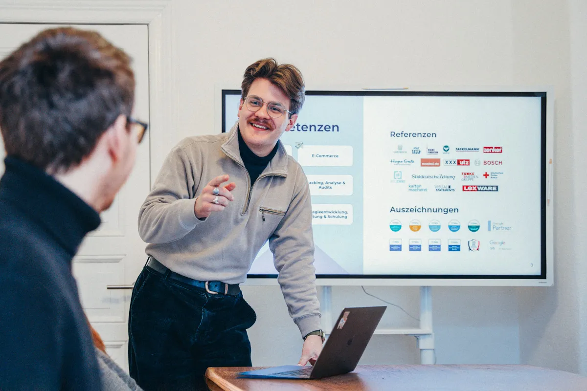 Team von Strehlow Media bei einer Besprechung vor einem Bildschirm mit Referenzen